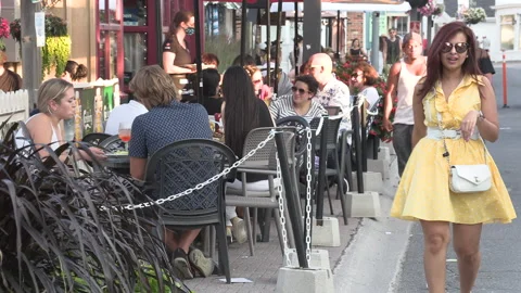 New normal after COVID with crowds of people outside enjoying a festival Видео 156421094