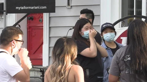 New normal after COVID with crowds of people outside enjoying a festival Stock Footage 156422402