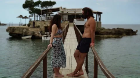 New normal at the beach in Camp de Mar, Palma de Mallorca. A couple stands on 스톡 동영상 131152485