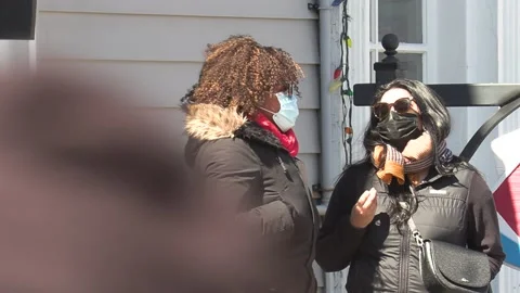 New normal COVID 19 Two people talking and wearing face masks on city street 库存影片 151569390