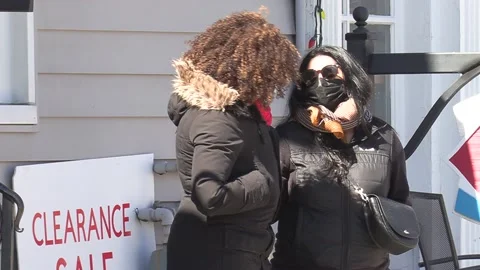 New normal COVID 19 Two people talking and wearing face masks on city street Video stock 151569472