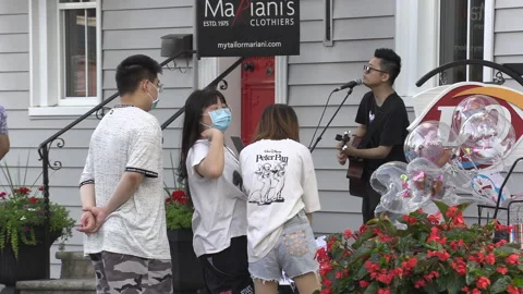 New normal  COVID small town main street Canada with people and face masks Видео 156423658