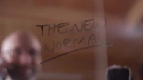 "The New Normal" getting erased on clear glass by a modern businessman Video stock 133284332