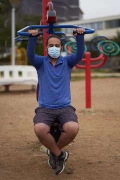 New normal. man with mask or mask mask and sportswear exercises in the park. Stock Photos