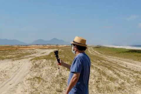The new normal - middle-aged man takes a picture of the beach Foto stock