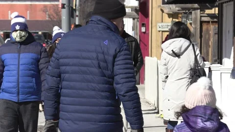 New normal with people walking down street wearing face masks in COVID pandemic 動画素材 149996091