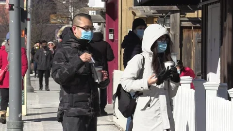 New normal with people walking down street wearing face masks in COVID pandemic Stockbeeldmateriaal 149996177