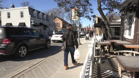 New normal with people walking on sidewalk wearing face masks in COVID pandemic Stock Footage 149995047