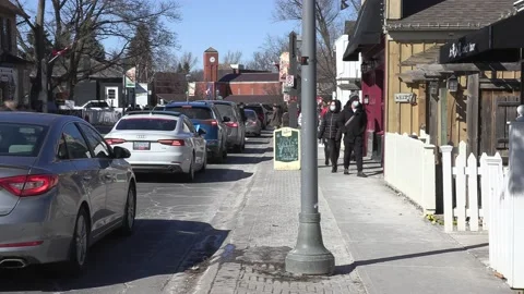 New normal with people walking on sidewalk wearing face masks in COVID pandemic Stockbeeldmateriaal 149995357