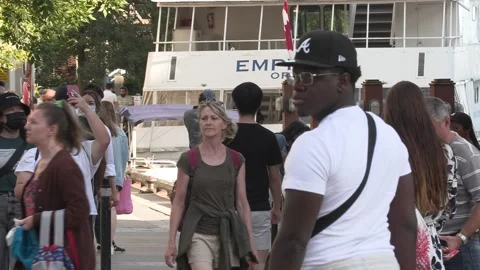 New normal post COVID with crowds of tourists and people in the city and boats Stock Footage 158903914