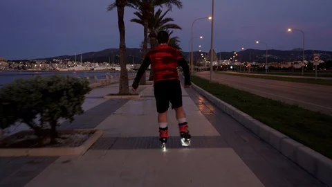 New normal situation: a man on a roller skates with lights in Spain takes pro 스톡 동영상 129616115