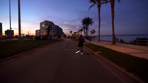 New normal situation: a man on a rollers skates with lights in Spain takes pr Video stock 129616051
