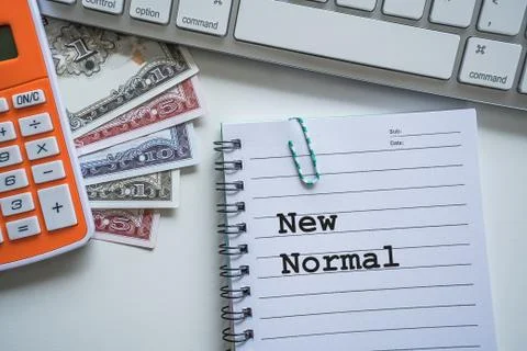 New Normal text with notepad, paper clip, keyboard, calculator and banknotes Stock Photos