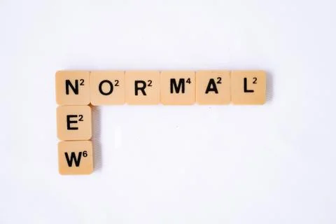 New Normal word on rustic plastic tiles alphabet puzzle board game. Stock Photos