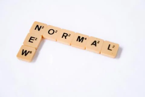 New Normal word on rustic plastic tiles alphabet puzzle board game. Stock Photos