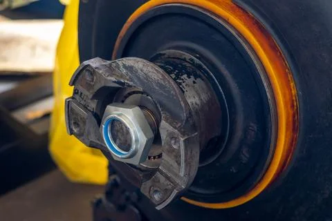 New nylon insert lock nut sits mounted on vehicle transmission output shaft.. Stock Photos