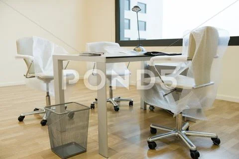 New office chairs covered in bubble wrap Stock-Fotos