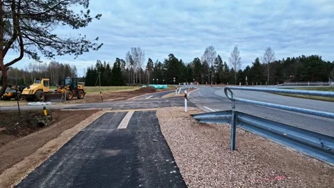 New pedestrian path merging with a country road construction Stock Footage 335893982