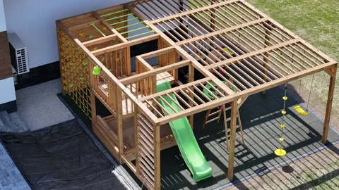New Playground Structure in Backyard Features Slide and Climbing Elements for Stock Footage 308562126