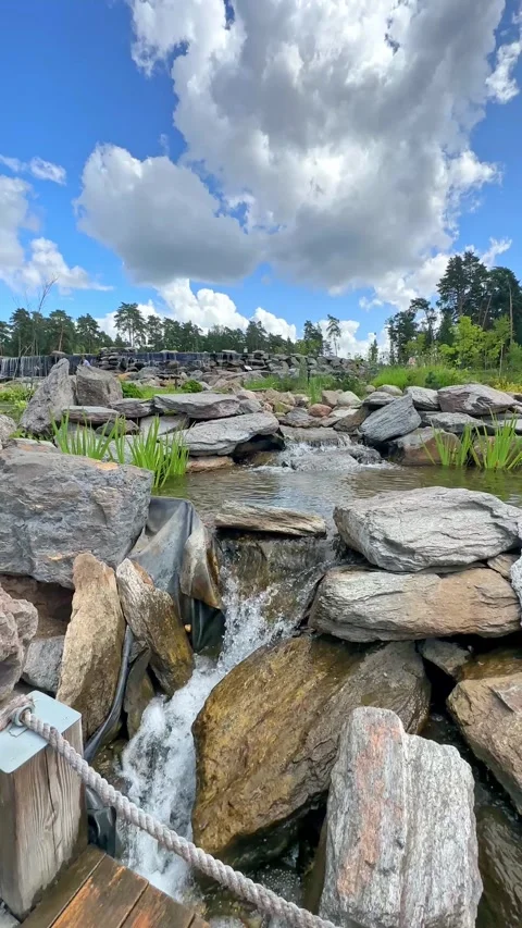  New pond with large multi-level waterfall lined with stones. Beautiful Nature.  Stock Footage 296238225
