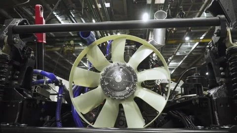 New powerful engine with cooling fan, mounted on chassis in assembly workshop. Stock Footage 330537835