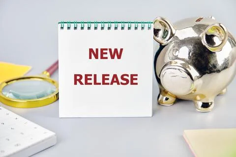 New Release written on a white notepad with business accessories close-up Stock Photos