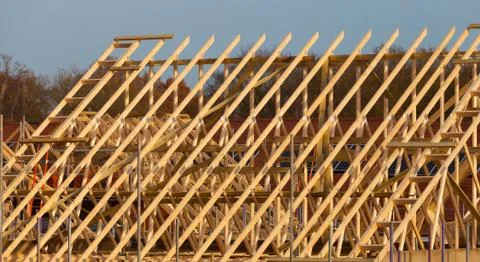 New residential construction home framing against a blue sky Stock Photos