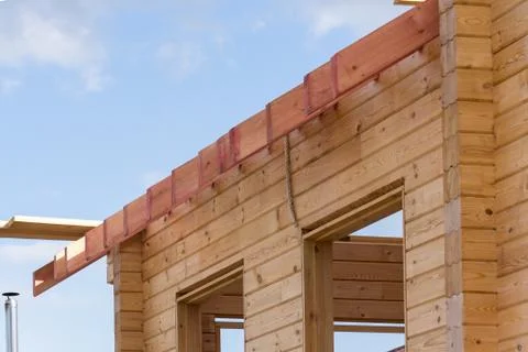 New residential construction home framing against a blue sky. Stock Photos