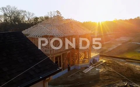 New residential construction house framing against a blue sky. Stock Photos