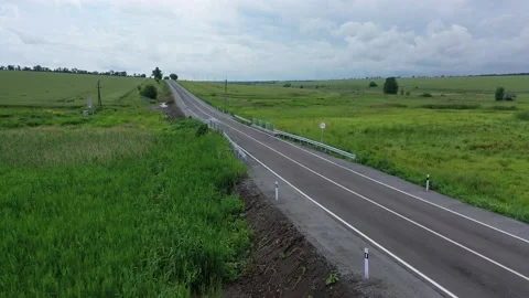 New road between green fields small bridge top view road sign Stock Footage 158697711