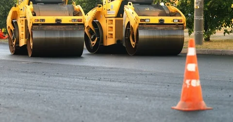 New road construction site. Team of workers put asphalt on a city street. Stock Footage 115866271