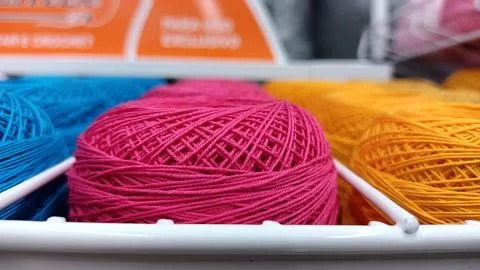 New round reels of thread of different colors in the store on the counter Foto stock