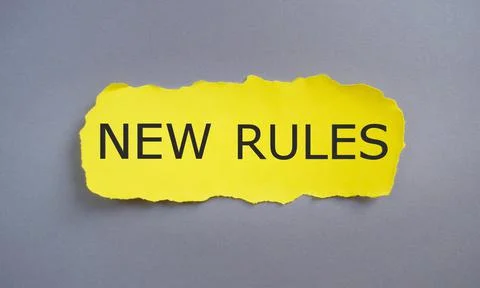 New Rules text written on yellow torn paper. Concept meaning recently one of Stock Photos
