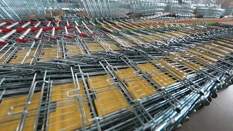 New shopping carts are in a row in the warehouse. Warehouse shopping carts. a Stock Footage 94899448
