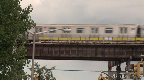 New Silver York Subway train on raised track with blue sky behind Stock Footage 39615257