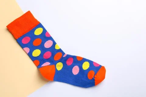 New sock with pattern on color background, top view. Space for text Foto stock