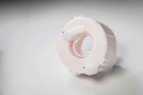 New spare part. Replaceable white plastic inner fuel filter on a gray gradient Foto stock