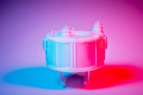 New spare part. Replaceable white plastic inner fuel filter in blue-red light on Fotos de archivo