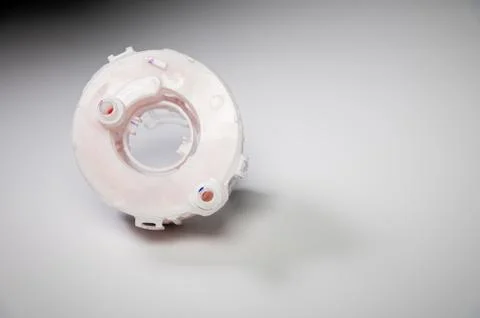 New spare part. Replaceable white plastic inner fuel filter on a gray gradient 스톡 사진