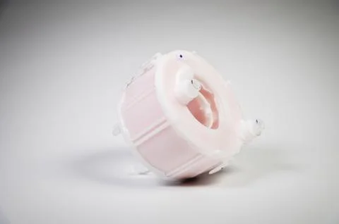 New spare part. Replaceable white plastic inner fuel filter on a gray gradient 스톡 사진
