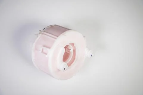 New spare part. Replaceable white plastic inner fuel filter on a gray gradient Stock Photos
