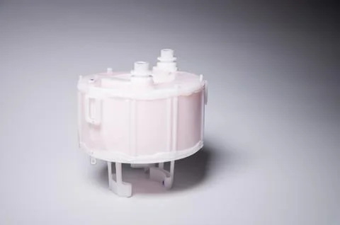 New spare part. Replaceable white plastic inner fuel filter on a gray gradient 스톡 사진