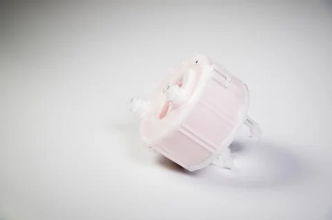 New spare part. Replaceable white plastic inner fuel filter on a gray gradient Fotos de archivo