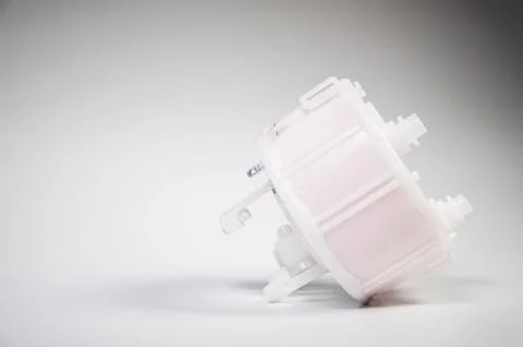 New spare part. Replaceable white plastic inner fuel filter on a gray gradient 스톡 사진