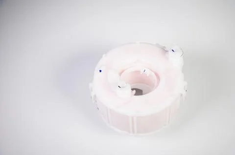 New spare part. Replaceable white plastic inner fuel filter on a gray gradient 스톡 사진