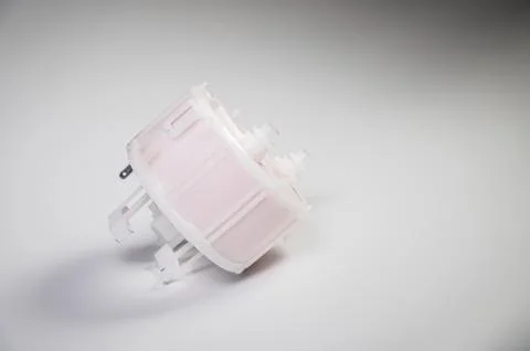 New spare part. Replaceable white plastic inner fuel filter on a gray gradient 스톡 사진