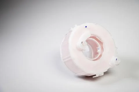 New spare part. Replaceable white plastic inner fuel filter on a gray gradient Foto stock