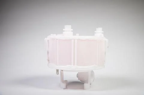 New spare part. Replaceable white plastic inner fuel filter on a gray gradient 스톡 사진
