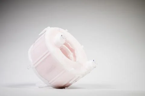 New spare part. Replaceable white plastic inner fuel filter on a gray gradient Foto stock