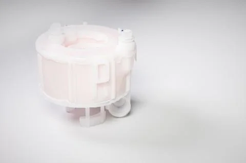 New spare part. Replaceable white plastic inner fuel filter on a gray gradient 스톡 사진
